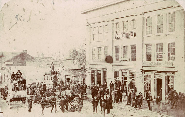 People and wagons outside a clothing store in Huntsville, Alabama.