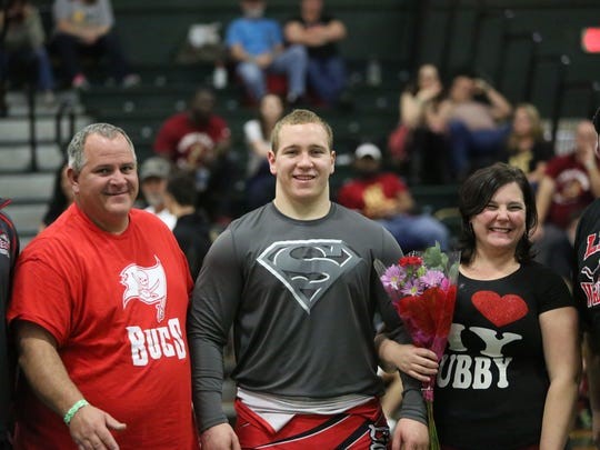 PROUD PARENTS – Jason and Traci Beyer with son at Leon High.