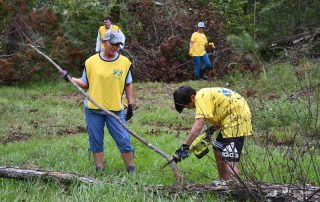 Carol Reilly and Jackson McCreless from the Tallahassee Florida Stake work on debris removal.