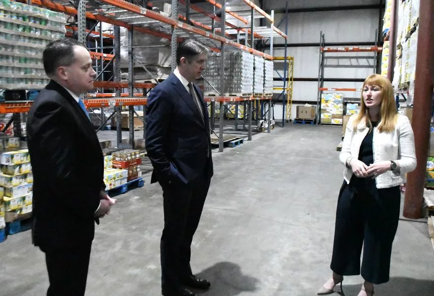 Elder Matthew S. Holland and President Benjamin Smith, tour the Second Harvest of the Big Bend food bank on Saturday with Second Harvest CEO Monique Ellsworth.