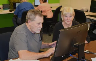 FamilySearch Volunteer Patty Casey assists a patron.